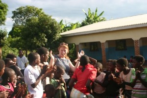 Travelers dance with the children at a rural orphan daycare project in Mulanje District of Malawi