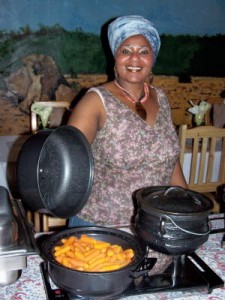 Liziwe Ngcolcoto, of Liziwes Bed & Breakfast in Cape Town, prepares carrots in a potjie pot, a traditional South African style of cooking.